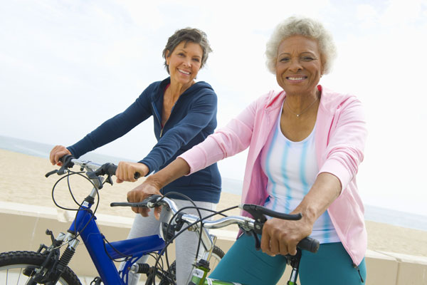 Portrait Of Happy Senior Woman Riding Bicycles
